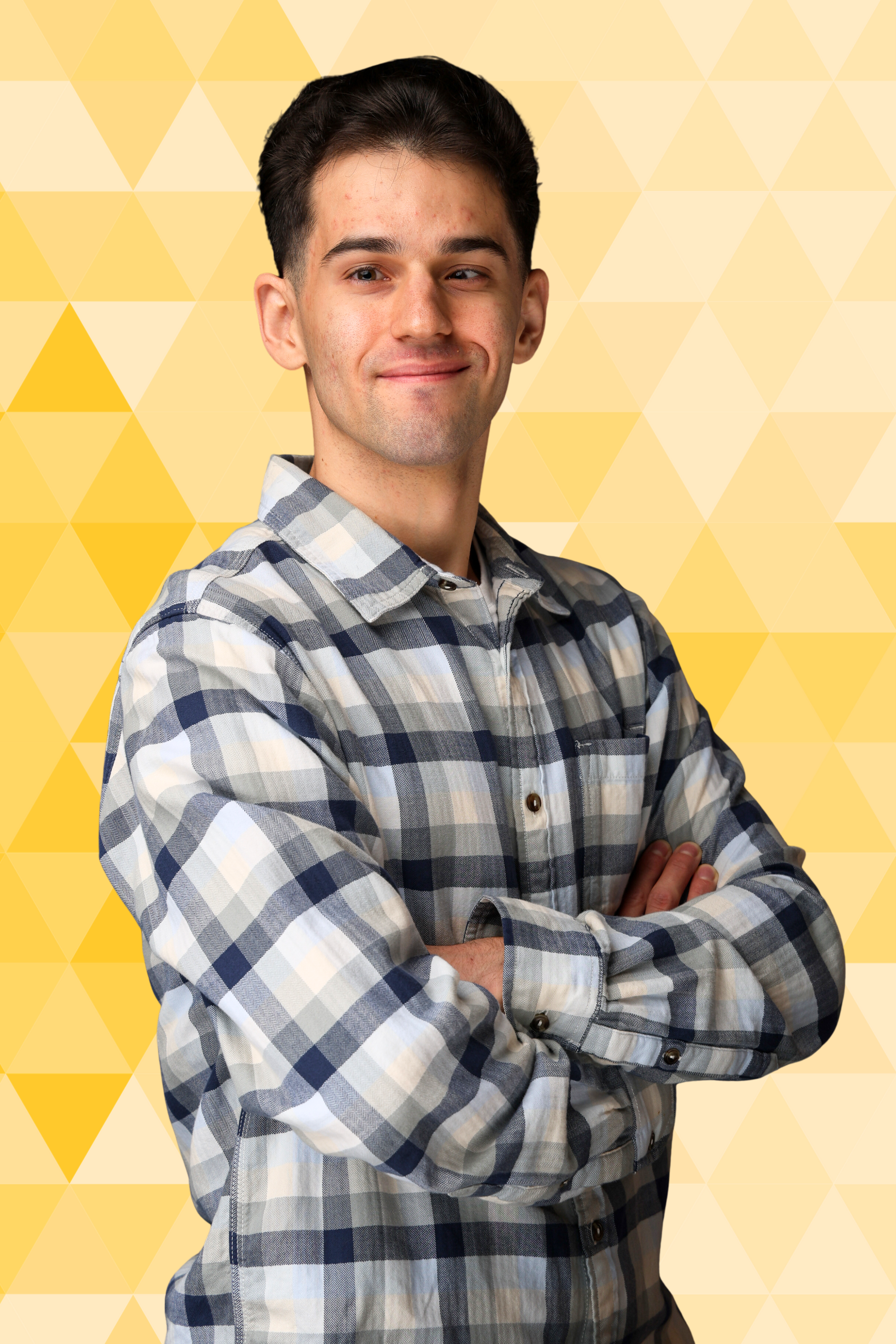 Headshot of Andrew Valiansky, a man with short brown hear wearing a white and blue checkered shirt.